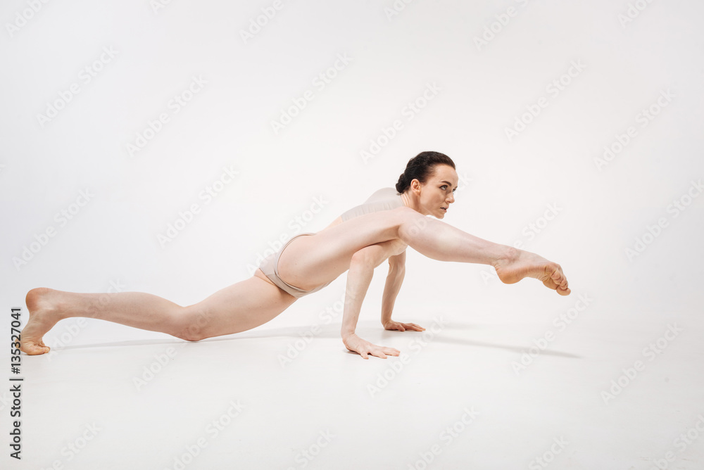 Flexible young ballet dancer stretching in the studio Flexible young ballet dancer stretching in the studio