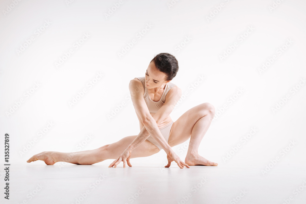 Involved young woman enjoying yoga in the studio Involved young woman enjoying yoga in the studio