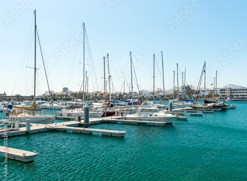 Empty slots in harbor, some boats, Spain