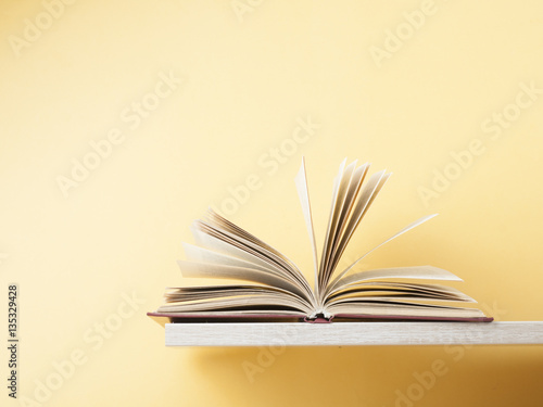 Open book on wooden shelf . Education background. Back to school. Copy space for text.
