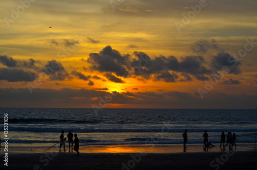 Sunset beach dawn evening sky clouds orange ocean sea people silhouettes