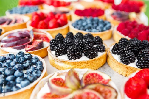 Obraz  z motywem Closeup of blackberry tart dessert tray assorted
