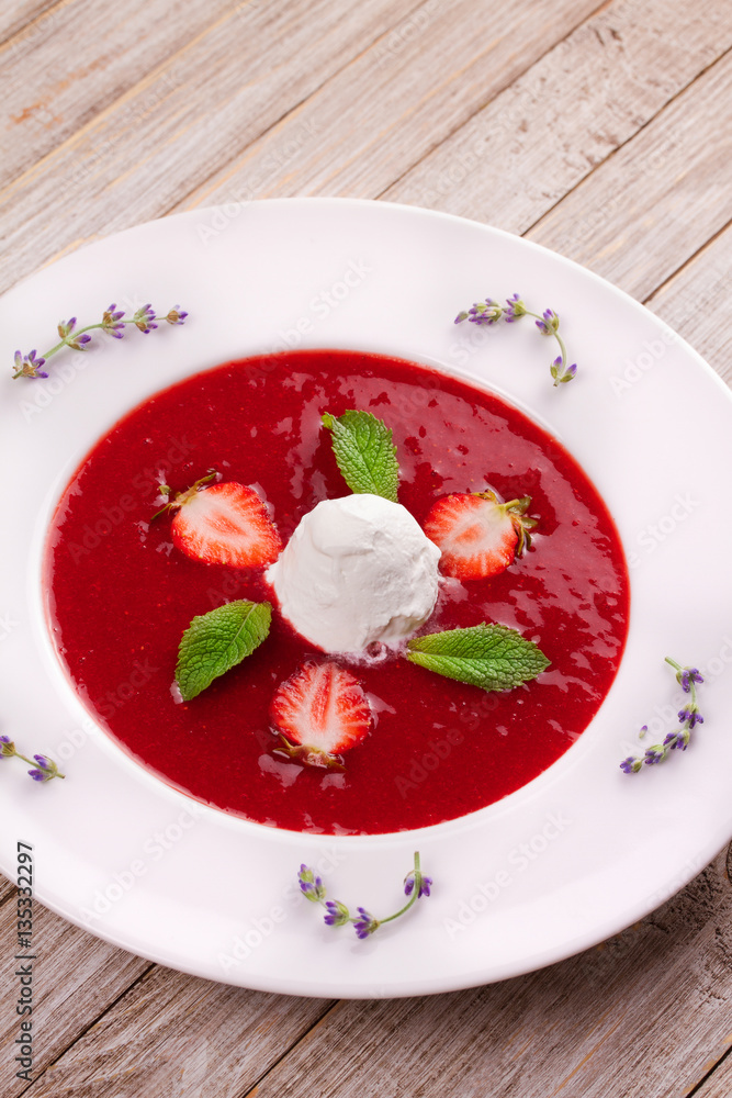 Strawberry soup with ice cream and mint. Pureed strawberries garnished with mint leaves topped with vanilla ice cream. Blended berries. Berry dessert Strawberry soup with ice cream and mint. Pureed strawberries garnished with mint leaves topped with vanilla ice cream. Blended berries. Berry dessert
