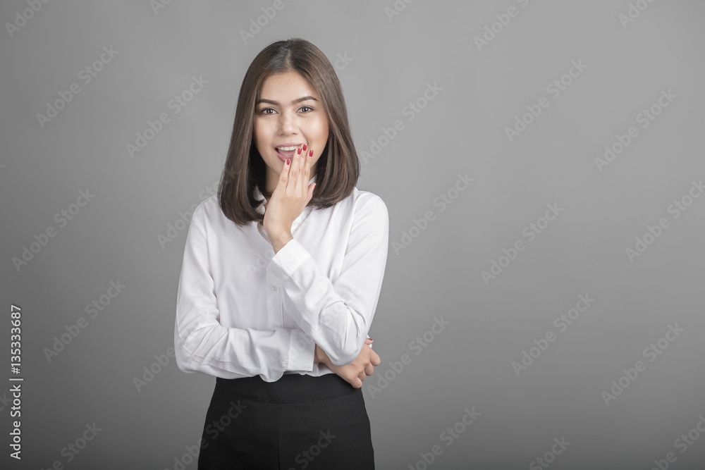 Beautiful Business Woman surprised with something on grey backgr Beautiful Business Woman surprised with something on grey backgr