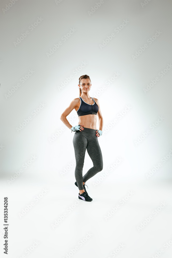 Muscular young woman athlete on white Muscular young woman athlete on white