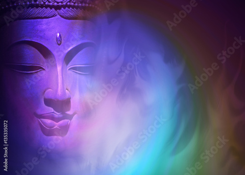 Mystical Buddha Background - ethereal colored gaseous vapors rising up with a partial Buddha head emerging from the darkness on left side and copy space on right