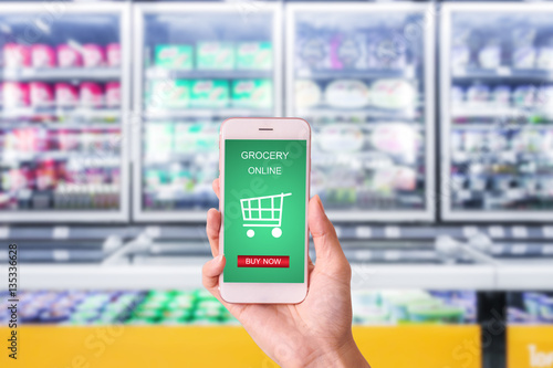 woman hand holding mobile with grocery online on screen with bl