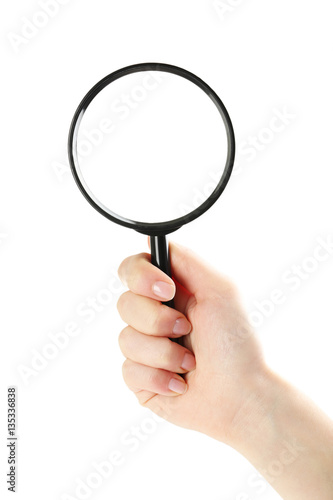 Female hand holding magnifying glass on a white background