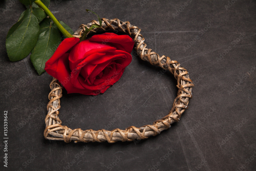 Red rose on dark background with wooden heart shaped, concept of romantic relationship. Congratulation on Valentine's day. Red rose on dark background with wooden heart shaped, concept of romantic relationship. Congratulation on Valentine's day.