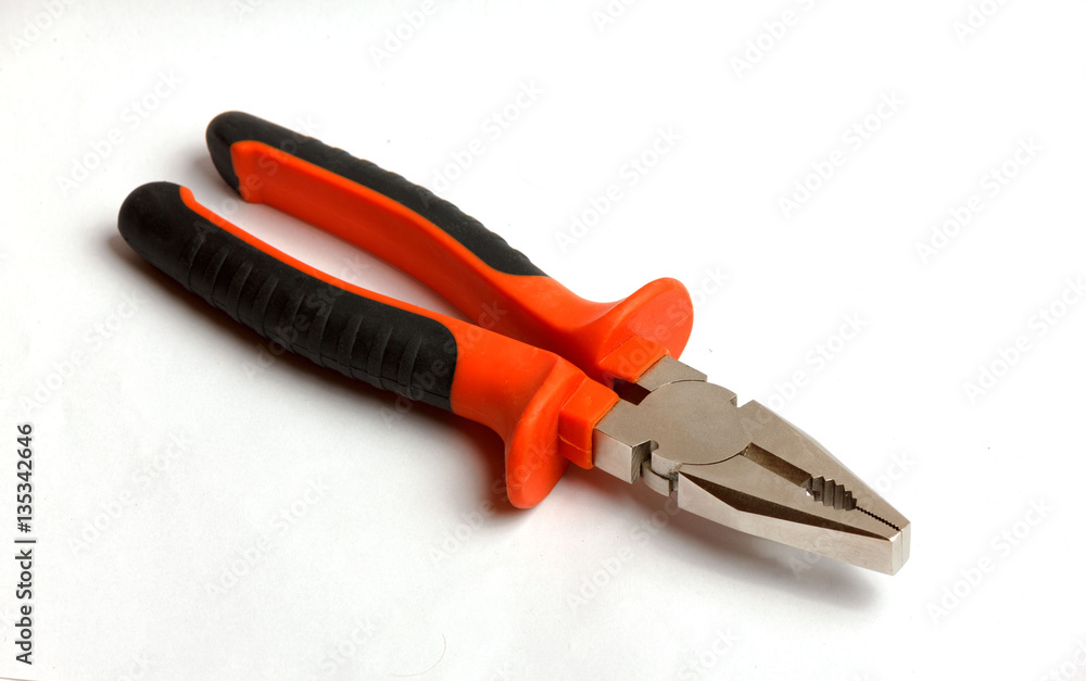 Red and black pliers on a white background Red and black pliers on a white background