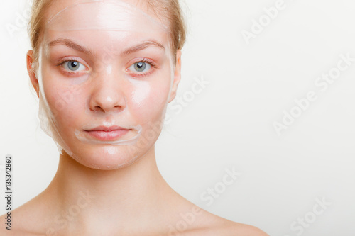 Woman in facial peel off mask.