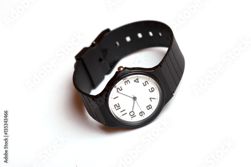 Classic black and white wrist watch on the white background photo