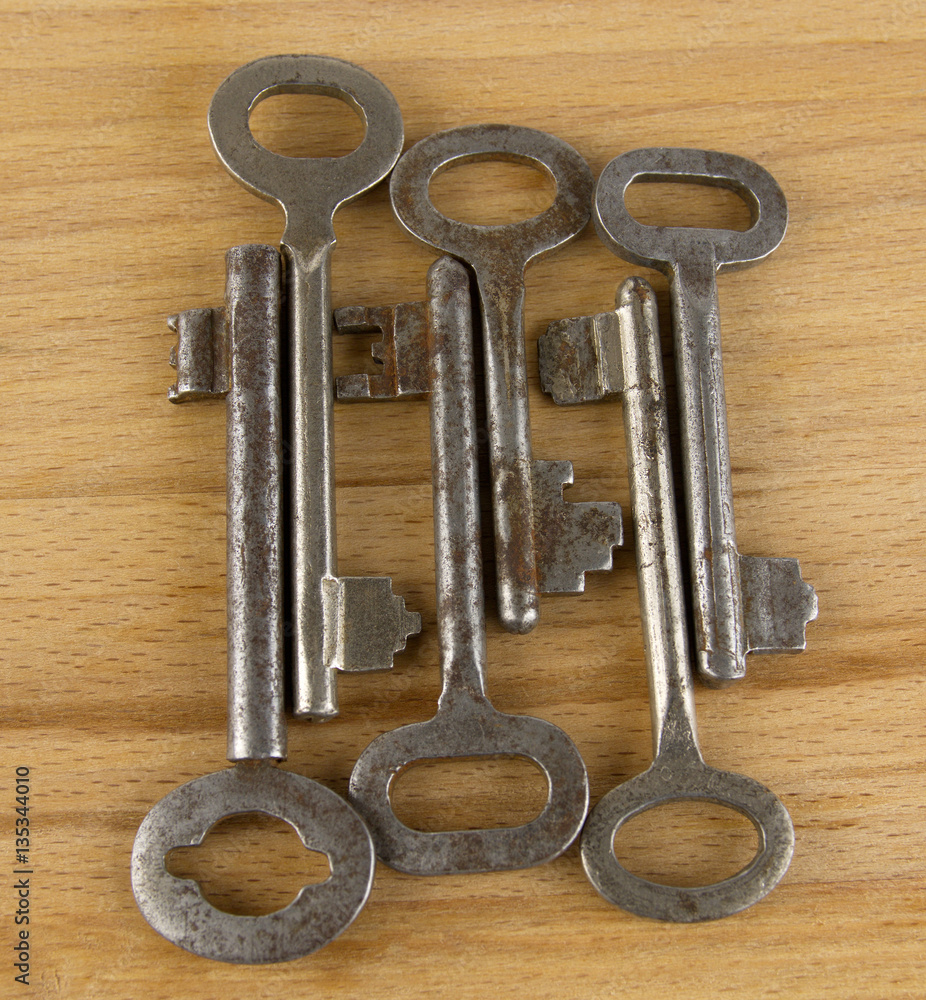 Old keys on a wooden board Old keys on a wooden board