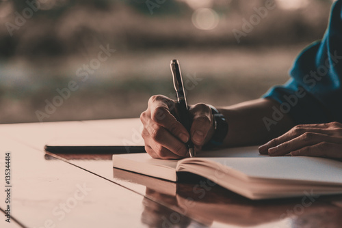 Wallpaper Mural Close up women hand on writing on notebook and work with smart p Torontodigital.ca