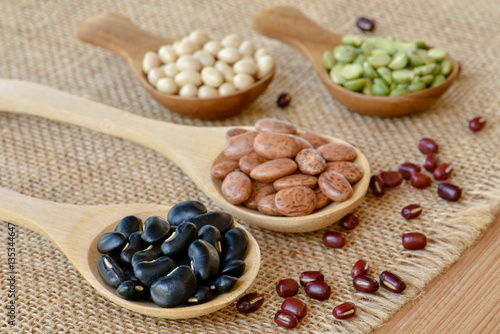 Prepared dried legumes on wooden spoon for cooking