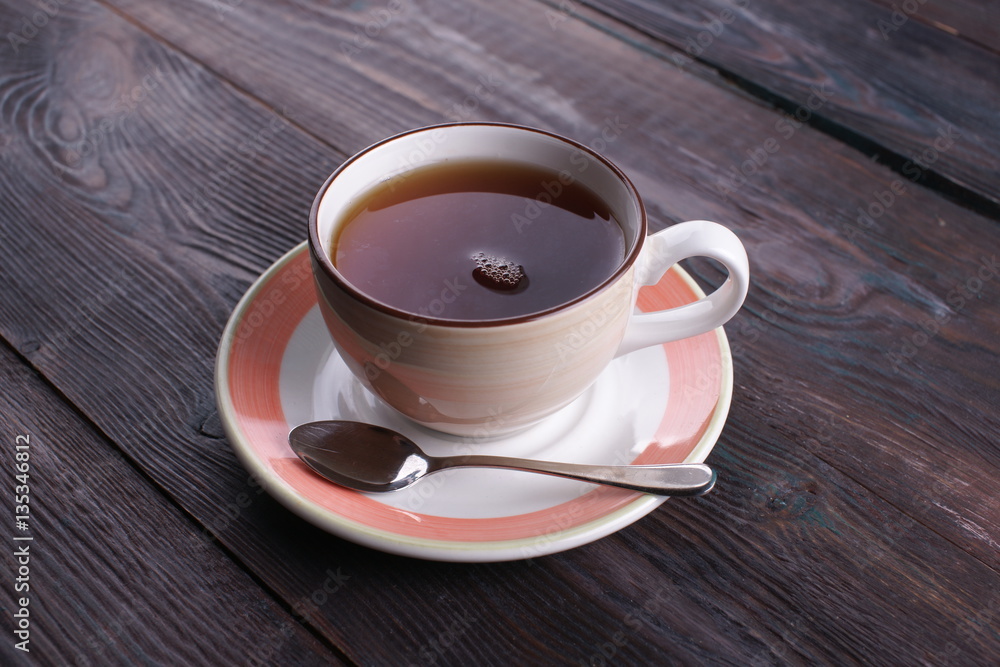 cup of black tea on a wooden table cup of black tea on a wooden table