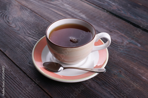 cup of black tea on a wooden table