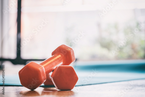 Pair of dumbbells on a wooden floor photo