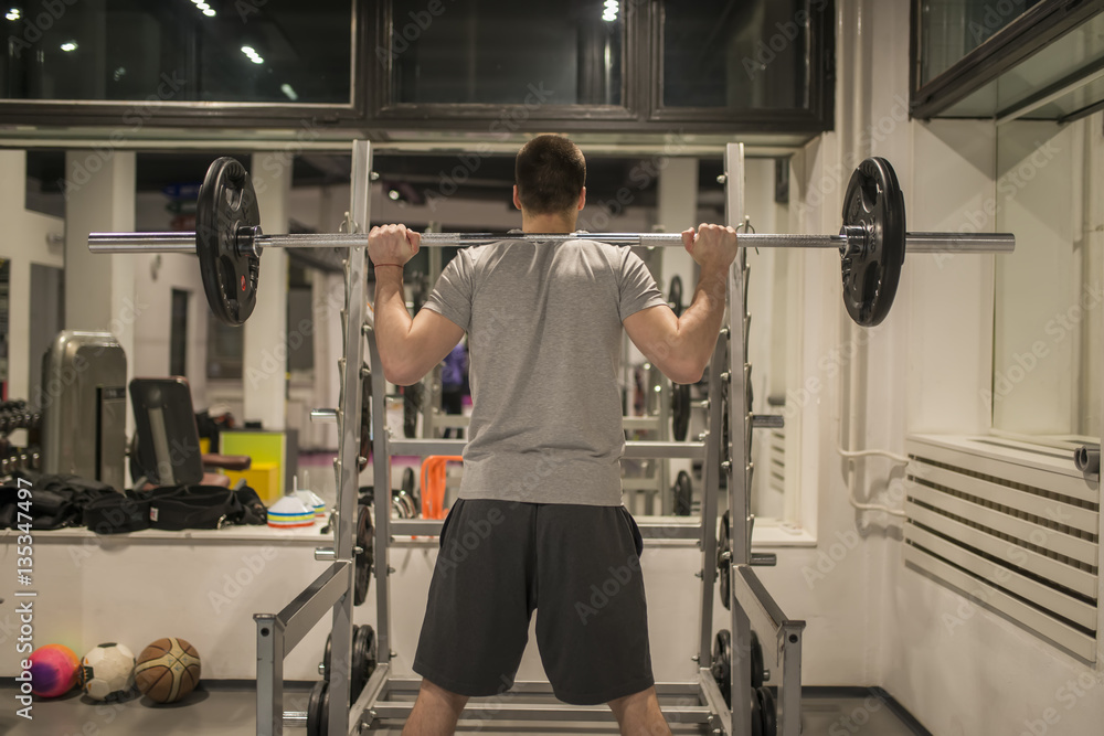 Man workout biceps muscles exercises with weight in gym Man workout biceps muscles exercises with weight in gym