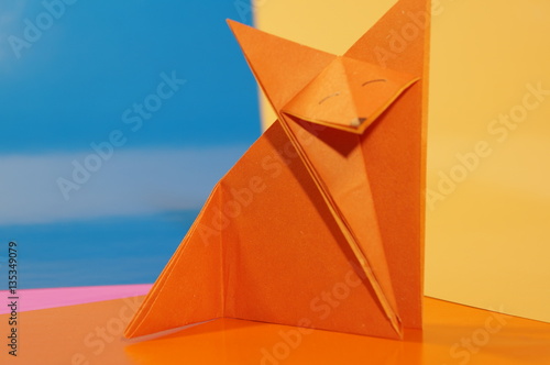  Paper origami fox isolated on a colorful background