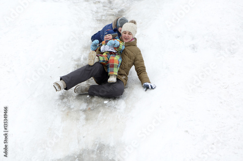 Family riding with a snow hill