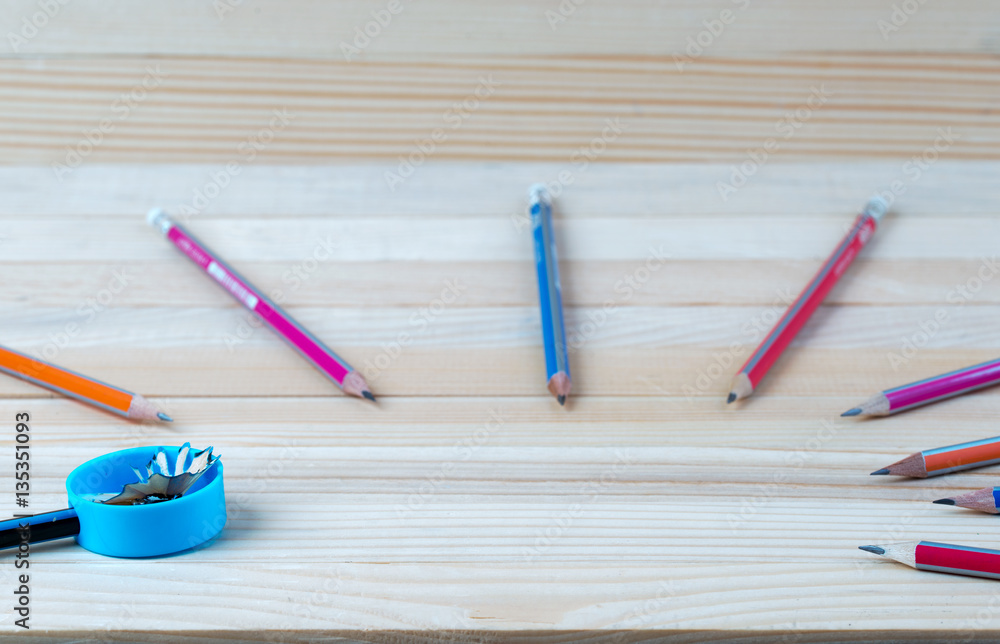 Obraz premium Pencil sharpener shavings on a wooden table. Back to school