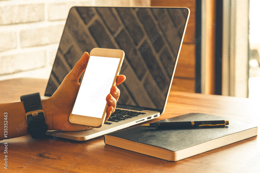 Εκτύπωση καμβά Close up of people hand using smartphone and laptop on wooden ta
