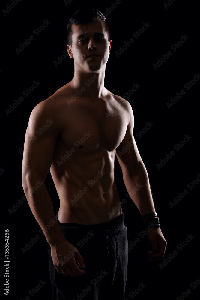 Handsome male model posing and showing his muscular body Handsome male model posing and showing his muscular body