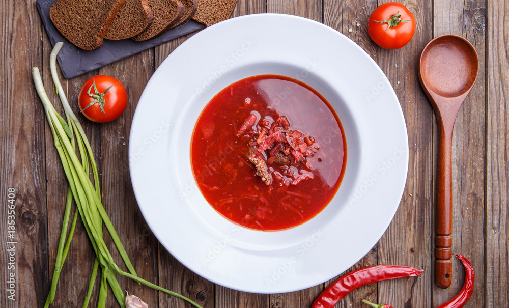Beet soup in white plate with vegetables Beet soup in white plate with vegetables