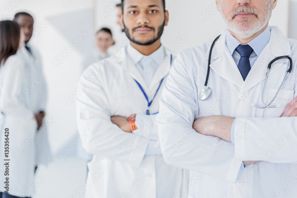 Professional physicians posing with confidence Professional physicians posing with confidence