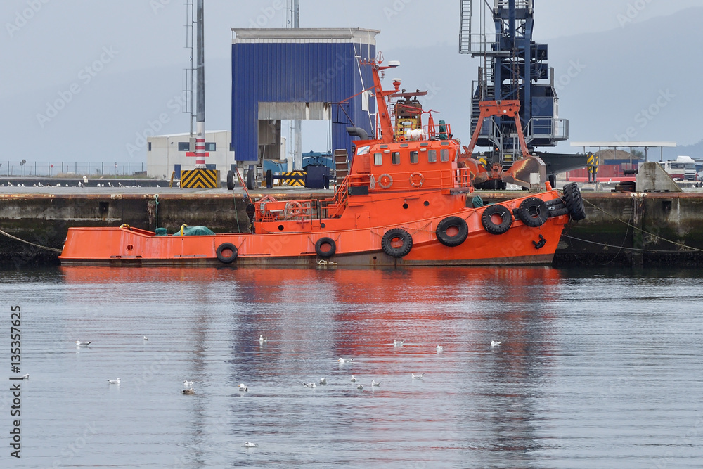 Fototapeta premium orange tug on the dock