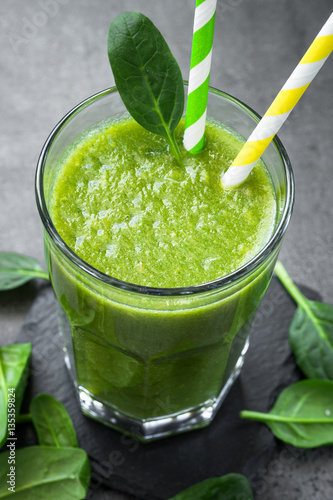 Healthy green spinach smoothie in glass