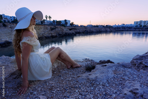Girl watching sunset. Beautiful sunset beach on a tropic Island. Cyprus Protaras