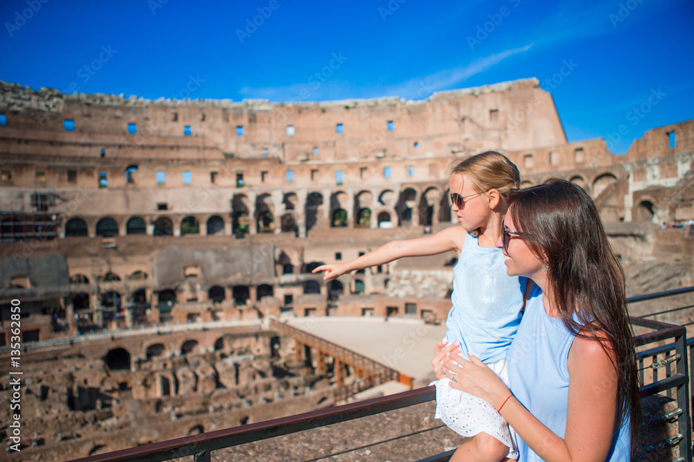 Family exploring Coliseum inside in Rome, Italy. Mother and her daughter portrait at famous places in Europe