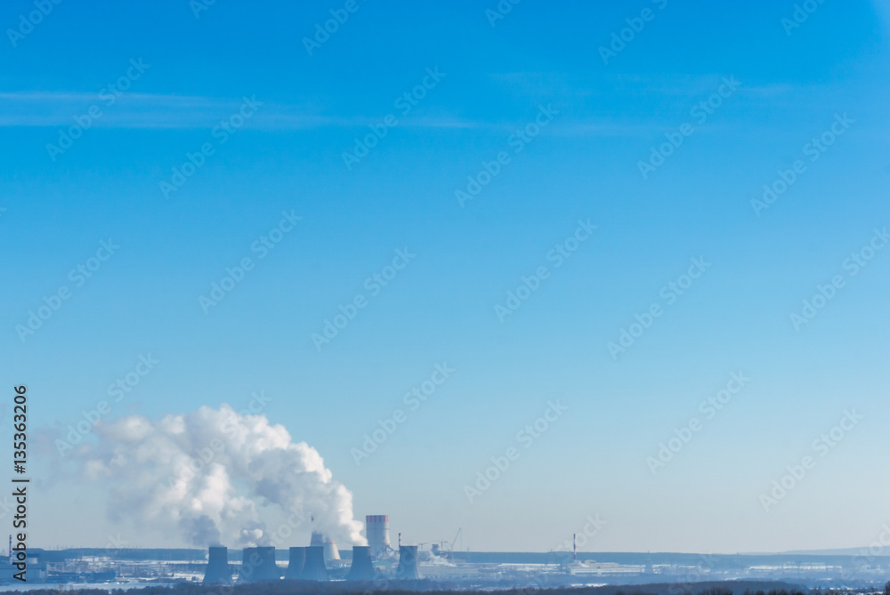 Naklejka premium Nuclear power plant on the sky background. Cooling towers of NPP with smoke. 