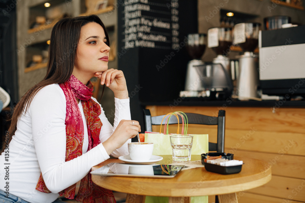 Young woman at coffee break in a cafe after shopping Young woman at coffee break in a cafe after shopping
