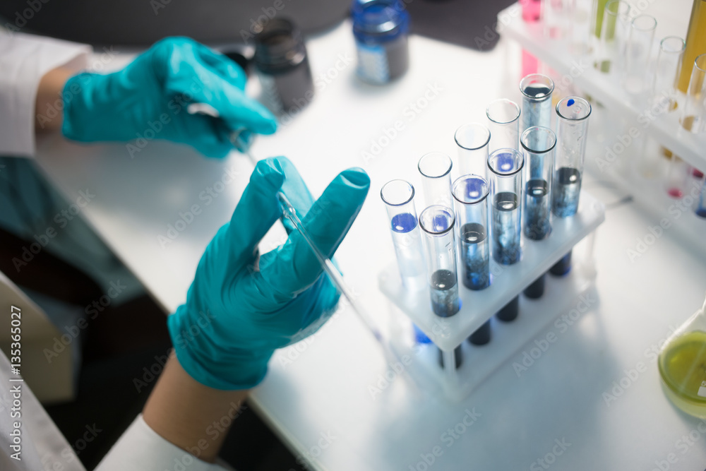 Laboratorian carries out chemical experiments Laboratorian carries out chemical experiments