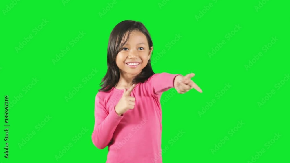 Cute little girl is playing shooting-game with her finger in the studio Cute little girl is playing shooting-game with her finger in the studio