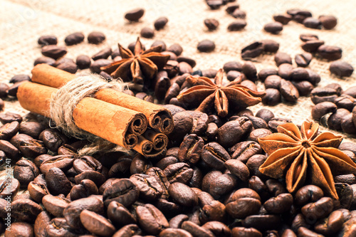 Coffee beans with cinnamon and anise on the sackcloth