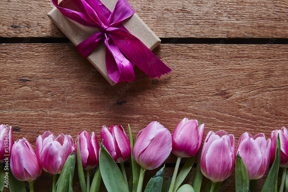a bunch of spring flowers and a wrapped gift for valentines day a bunch of spring flowers and a wrapped gift for valentines day
