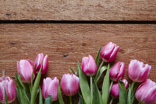 Fototapeta Naklejka Na Ścianę i Meble -  a bunch of violet tulips on wooden table valentines day