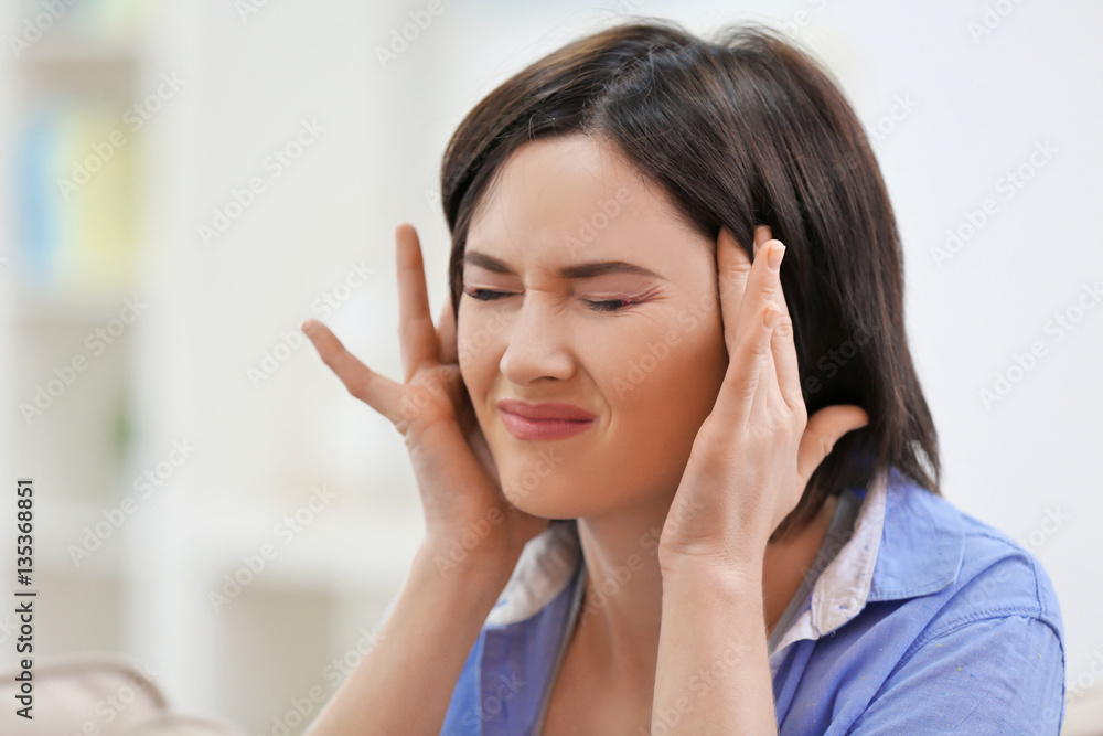 Beautiful young woman suffering from headache at home, close up Beautiful young woman suffering from headache at home, close up