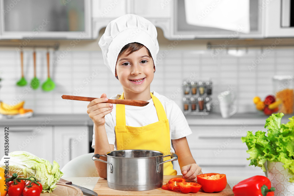 Cute boy cooking in kitchen at home Stock Photo | Adobe Stock