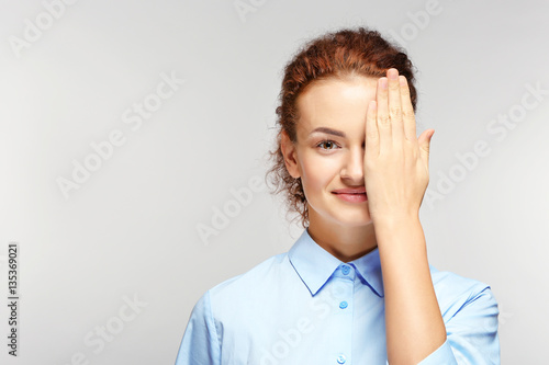 Young woman on grey background