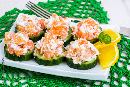 Appetizer with salmon, cucumber and goat cheese