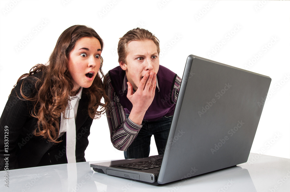 Amazed couple on line with a laptop Amazed couple on line with a laptop