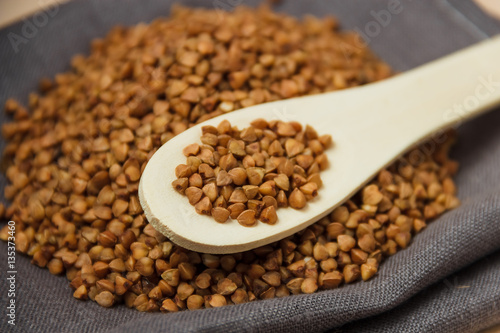 buckwheat grains and wooden spoon