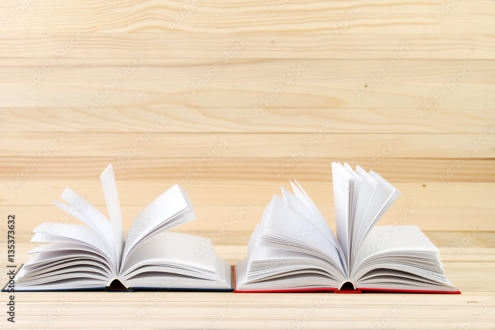 Open books on wooden table. Open books on wooden table.