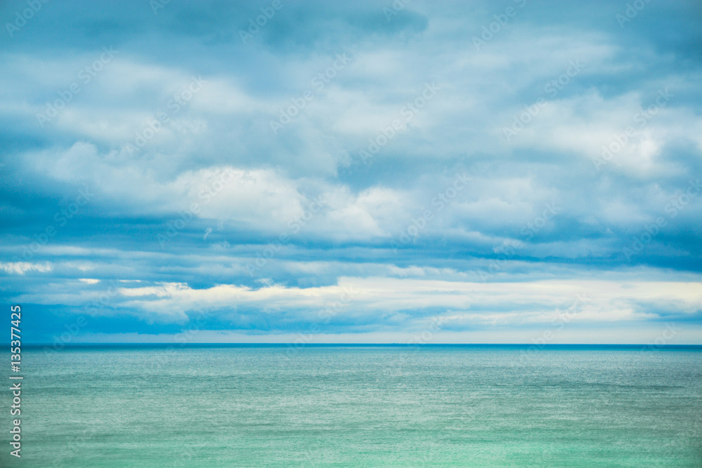 Sea, horizon and clouds in the sky.