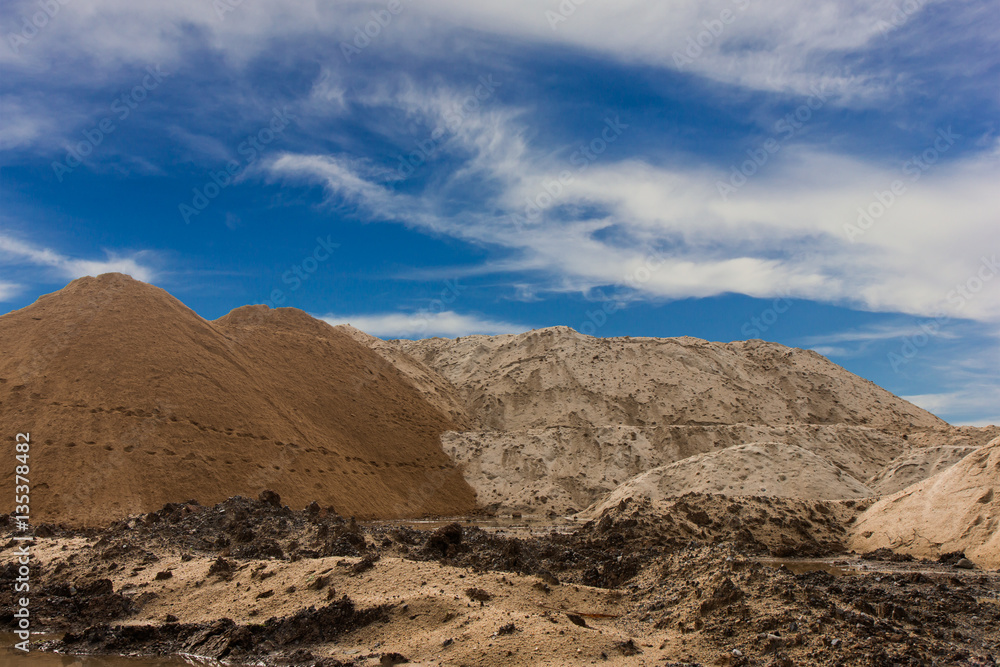 Wet sand hill against the sky.